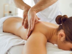 massage therapist massaging a woman